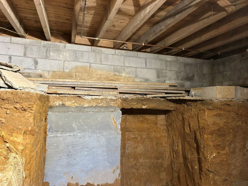Concrete foundation underpinning beneath existing West Chester home