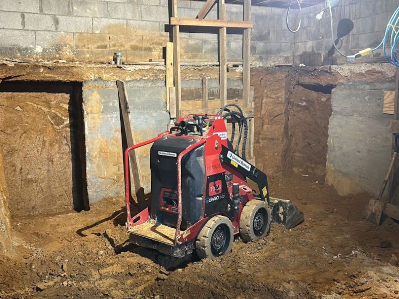 Compact excavation equipment working beneath West Chester home