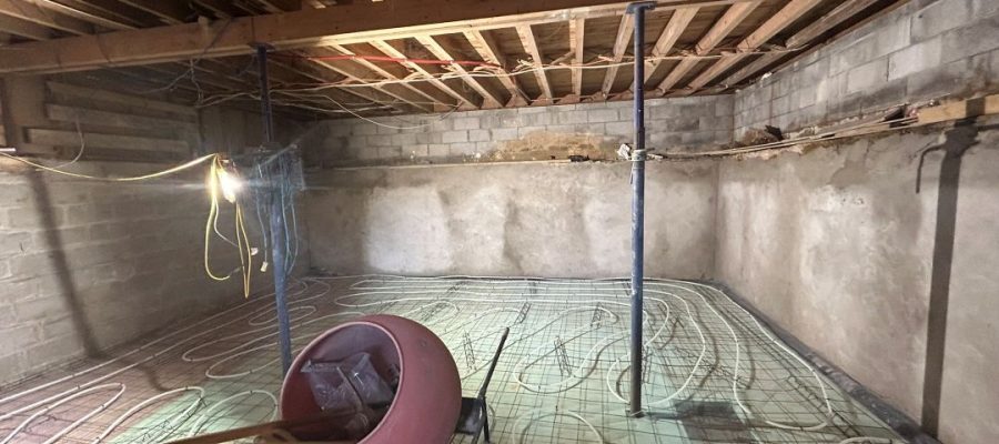 Basement floor reinforcement and radiant heating before concrete placement