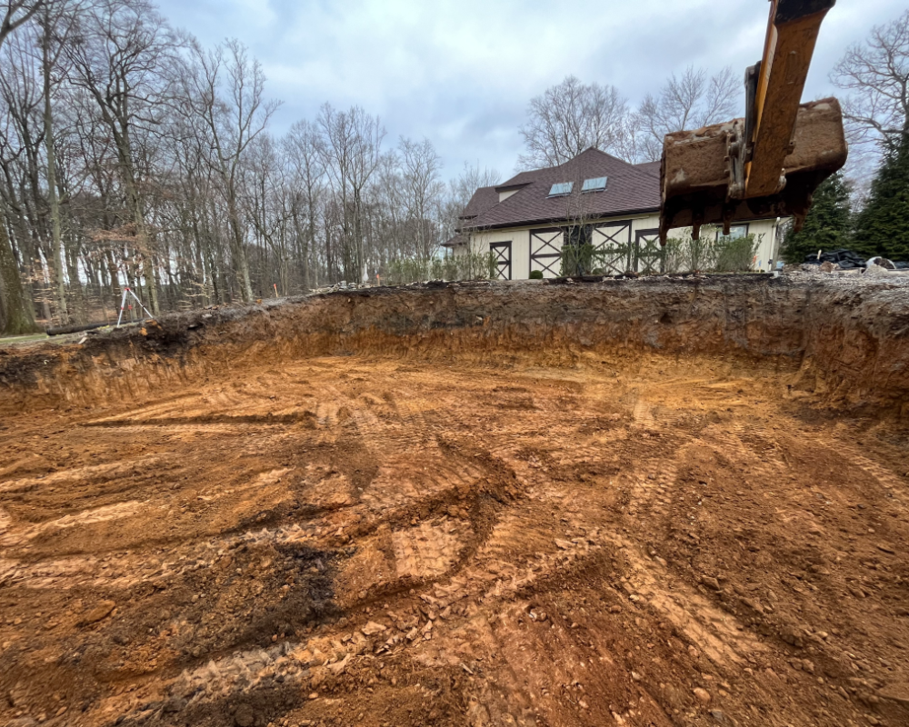 Residential excavation project with large basement cut and site preparation.