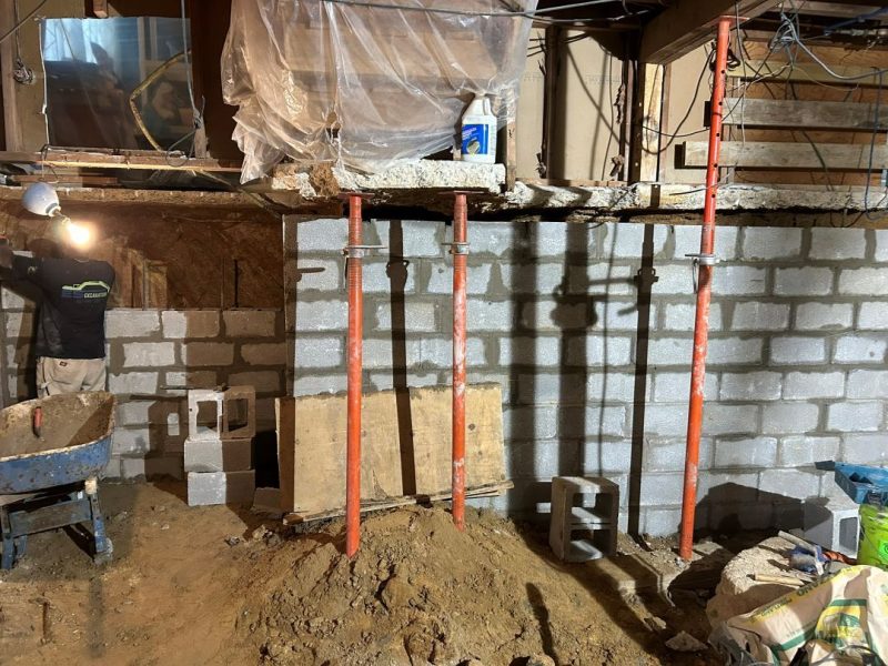 New foundation wall beneath underpinned West Chester home